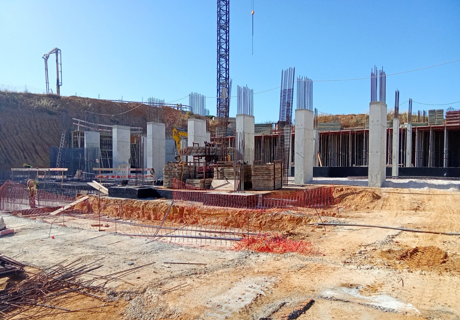 Concrete columns and a tower crane on the Ponte do Vau Beach Resort construction site in the Algarve